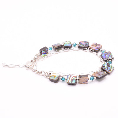 Dazzling Abalone and Crystal Double Strand Bracelet handcrafted by artist Karley Smith. Made of abalone, Swarovski Crystal and sterling silver. Bracelet is 7.25" long when clasped shut and has 1" extender.