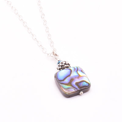 Abalone Crystal Pendant Necklace handcrafted by artist Karley Smith. Pendant made of sterling silver, Swarovski Crystal and abalone. Sterling silver chain included. Pendant measures 1.10" x 0.50" including bail and chain is 18" long.