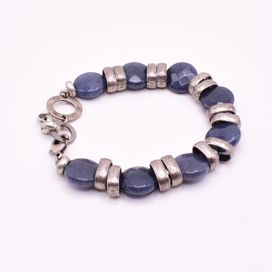 Blue jade coin bracelet handcrafted by artist Karley Smith. She used antique silver and blue jade to create it. Bracelet is 7.5" long with 1" extender.