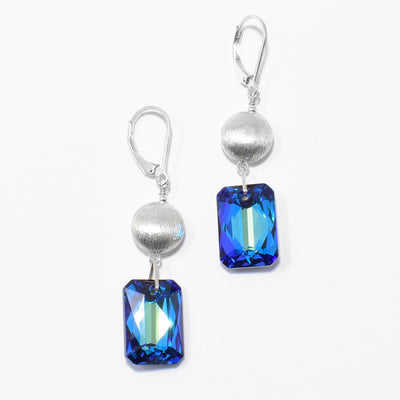 Dazzling Bermuda Blue Rectangle Earrings with Silver Beads handcrafted by artist Debra Nelson. Made of sterling silver, brushed sterling silver and Bermuda Blue Swarovski Crystal. Each earring measures 1.88" x 0.44" including hook.