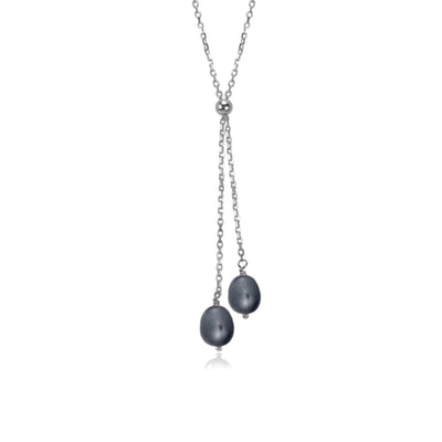 Black Pearl Lantern Lariat Necklace handcrafted by artist Pamela Lauz. Made of sterling silver and genuine black freshwater pearls. Necklace is 17" long and lariat hangs down 2.15" (5.5cm).