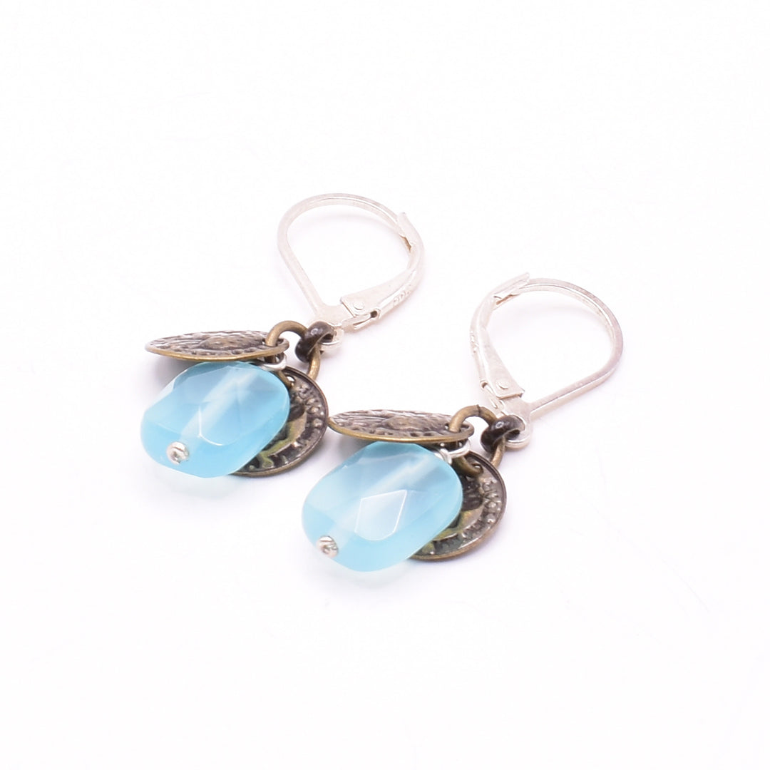 Unique lever back earrings handcrafted by artist Karley Smith. She has used brass, glass and sterling silver to create them. Ear hooks are sterling silver. Each earring measures 1.35" x 0.40" including hook.