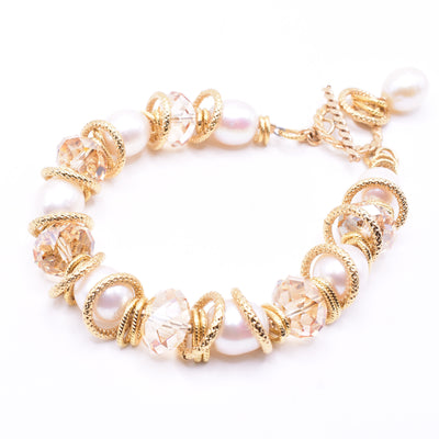 Chunky Crystal and Pearl Bracelet handcrafted by artist Karley Smith. Made of freshwater pearls, gold-filled wire and adornments, gold-plated rings and Swarovski Crystal. Bracelet is 8" long when clasped shut.