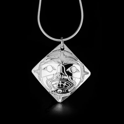 Double-Sided Diamond-Shaped Moon Pendant hand-carved by Coast Salish artist Gilbert Pat. Made of sterling silver. Pendant measures 1.25" x 1.20" including bail. Chain not included.