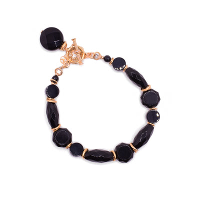 Dazzling black onyx bracelet handcrafted by artist Karley Smith. She used gold-filled rings and black onyx to create this piece. Bracelet is 8.5" long when clasped shut. Gold-fill safety chain adds extra element of security.