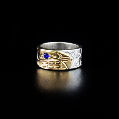 Orca ring hand-carved by Coast Salish and Cree artist Richard Lang. Made of 14K gold and sterling silver. Blue lab-created stone in eye of orca. Width of band is 0.38". Size 9.