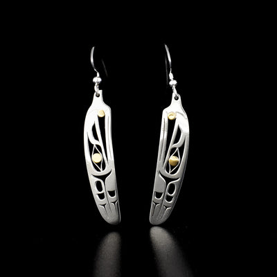 Elegant raven feather earrings by Tahltan artist Grant Pauls. Made of 18K gold and sterling silver. Each earring measures 2" x 0.38" including hook.
