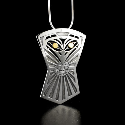 Unique pierced raven sun shield pendant by Tahltan artist Grant Pauls. Made of 18K gold and sterling silver. Pendant measures 1.95" x 1.40". Hidden bail on back. Chain not included.