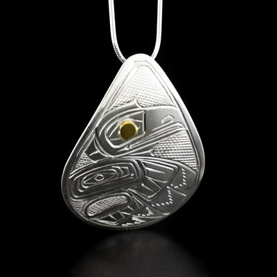 Stunning raven pendant hand-carved by Heiltsuk artist Reg Gladstone. Made of 14K gold and sterling silver. Pendant measures 2" x 1.5". Hidden bail on back. Chain not included.