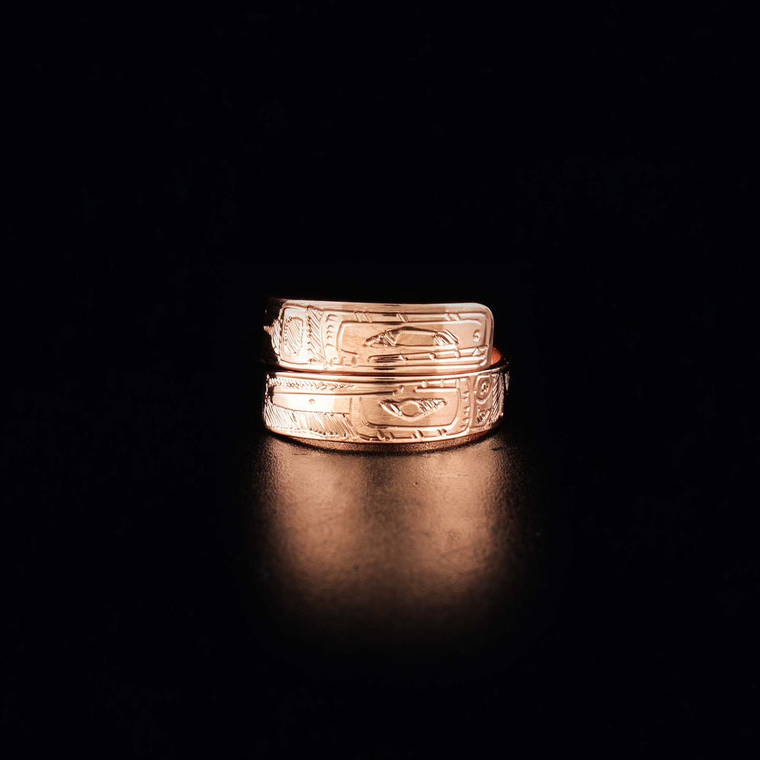 This Orca and Hummingbird ring is made of copper and has a single band that wraps around the finger twice. There are depictions of the Orca and the Hummingbird carved into the surface of the band.