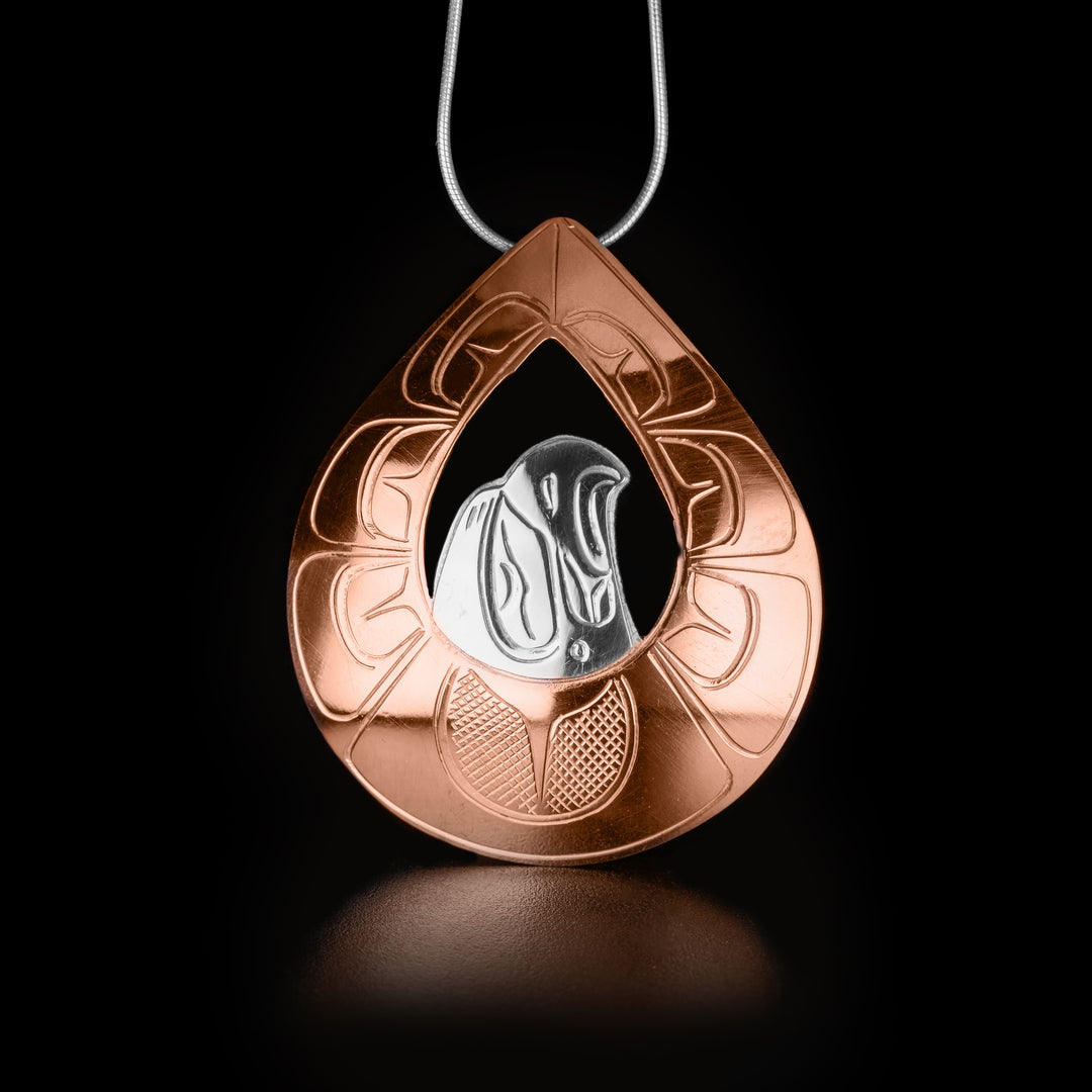 Large Silver and Copper Eagle Pendant hand-carved by Kwakwaka'wakw artist John Lancaster. He has used sterling silver for the head of the eagle and copper for the wings. Pendant measures 2.36" x 1.97". Hidden bail on back. Chain not included.