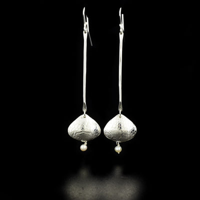 Elegant Long Freshwater Pearl Shoreline Earrings handcrafted by artist Victoria Poynton. Made of sterling silver and freshwater pearls. Victoria has used vintage French lace to emboss the design. Each earring measures 3.25" x 0.75" including hook.