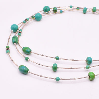 Stunning Long Silver Tibetan Turquoise Station Necklace handcrafted by artist Karley Smith. She has used sterling silver and Tibetan turquoise for this piece. Necklace is 50" long and larger, round beads are 0.38" in diameter.