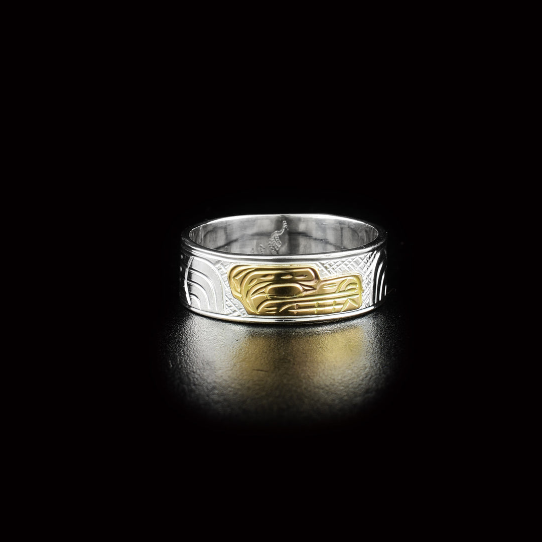 This 14K gold and sterling silver Bear ring has the profile of a bear's head facing the right in the center. There are designs along the rest of the ring of the body and paws of the bear.