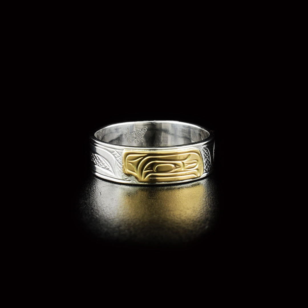 Dazzling Raven ring hand-carved by Kwakwaka'wakw artist Victoria Harper. Made of 14K gold and sterling silver. Width of band is 0.25".