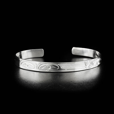 Hummingbird cuff bracelet hand-carved by Kwakwaka'wakw artist Victoria Harper. Made of sterling silver. Bracelet is 6.13" long with 0.88" gap and has width of 1".