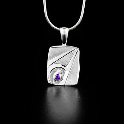 Rectangular Amethyst Hummingbird Pendant hand-carved by Haisla artist Hollie Bartlett. She used sterling silver to create this piece and set an amethyst in the eye of the hummingbird. Pendant measures 1.20" x 0.60" including bail. Chain not included.