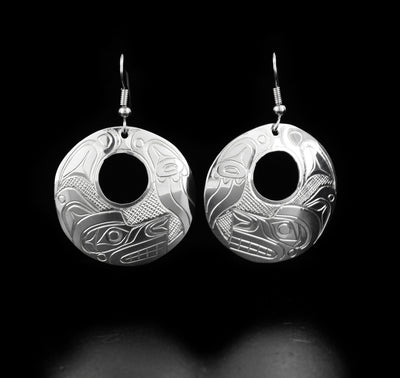 Elegant round cut out wolf earrings hand-carved by Kwakwaka'wakw artist Don Lancaster. Made of sterling silver. Each earring measures 2" x 1.25" including hook.