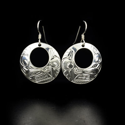 Round Sterling Silver Wolf Cut Out Earrings hand-carved by Coast Salish and Cree artist Richard Lang. Each earring measures 1.63" x 1" including hook.
