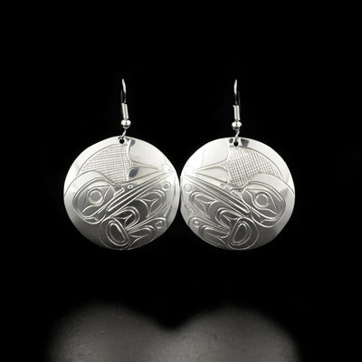 Delicate round hummingbird earrings hand-carved by Kwakwaka'wakw artist Don Lancaster. Made of sterling silver. Each earring measures 2" x 1.25" including hook.