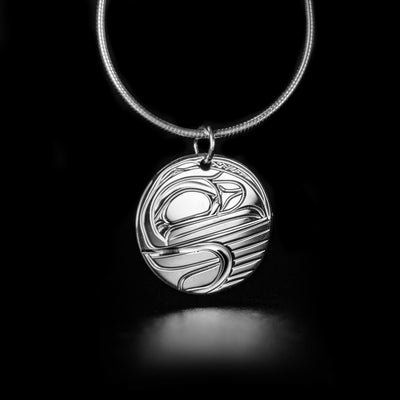 Round Sterling Silver Raven Pendant hand-carved by Kwakwaka'wakw artist Victoria Harper. Pendant measures approximately 0.80" x 0.70" including bail. Chain not included.