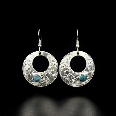 Silver Eagle Cut Out Earrings with Turquoise hand-carved by Coast Salish and Cree artist Richard Lang. Made of sterling silver and turquoise. Each earring measures 1.75" x 1" including hook.