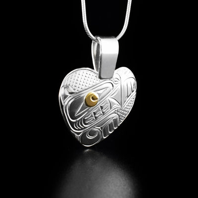Silver and Gold Bear Heart Pendant hand-carved by Coast Salish and Cree artist Richard Lang. He has used 14K gold for the iris and pupil of the bear's eye and sterling silver for the rest of the piece. Pendant measures 1.50" x 1.13" including bail. Chain not included.