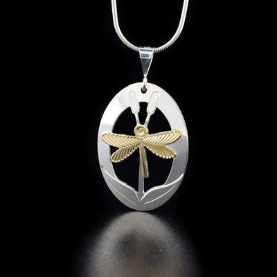 Stunning Silver and Gold Dragonfly Pendant hand-carved by artist Brett Borrie. He has used 10K gold for the dragonfly and sterling silver for the rest of the piece. Pendant measures 1.70" x 0.95" including bail. Chain not included.