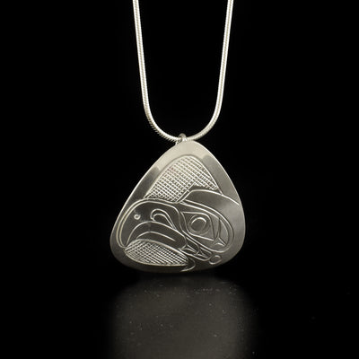 Silver Triangle Eagle Head Pendants hand-carved by Kwakwaka'wakw artist Don Lancaster. Made of sterling silver. There are two pendants to choose from: one where the eagle is facing upwards and one where the eagle is facing left. Each pendant measures 1.40" x 1.25" and has hidden bail on back. Chain not included.