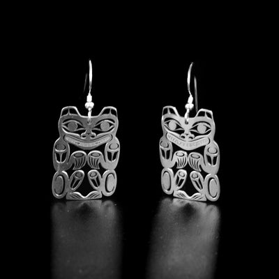 Dazzling bear earrings by Tahltan artist Grant Pauls. Made of sterling silver. Each earring measures 1.70" x 0.80" including hook.