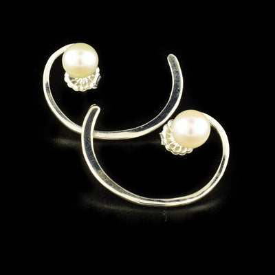 Elegant stud earrings handcrafted by artist Victoria Poynton. Made of sterling silver and freshwater pearl. Each earring measures 1.1" x 0.8".