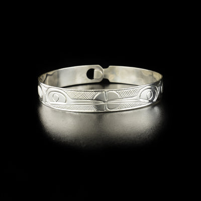 Double hummingbird clasp bracelet hand-carved by Kwakwaka'wakw artist Norman Seaweed. Made of sterling silver. Bracelet has circumference of 7.75" when clasped shut. The clasp design makes it fit like a smaller style bangle and can fit various wrist sizes. Bracelet has width of 0.38".