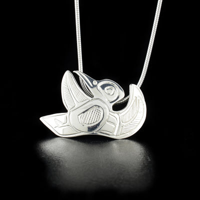 Unique Sterling Silver Flying Hummingbird Pendant hand-carved by Kwakwaka'wakw artist Norman Seaweed. Pendant measures 1.1" x 0.9". Hidden bail on back. Chain not included.