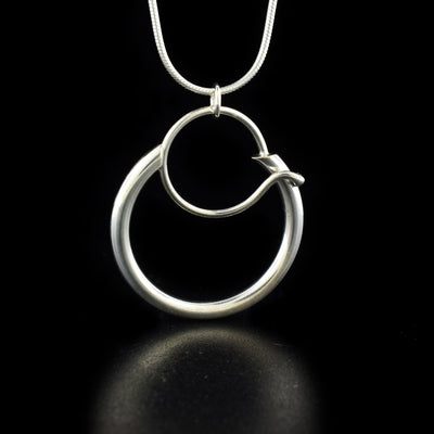 Elegant pendant necklace by artist Lynda Constantine. She used sterling silver to create the pendant. Sterling silver snake chain included. Pendant measures 1.63" x 0.94" including bail and chain is 18" long.