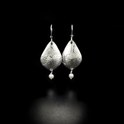 Elegant earrings handcrafted by artist Victoria Poynton. Made of sterling silver and freshwater pearl. Each earring measures 1.8" x 0.7" including hook.