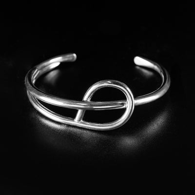 Medium-sized Simplicity Cuff Bracelet handcrafted by artist Lynda Constantine. Made of sterling silver. Bracelet is 6" long with 1" gap and is 0.88" wide at widest.