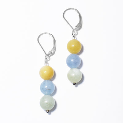 Colourful lever back earrings handcrafted by artist Debra Nelson. Ear hooks and wire are made of sterling silver and three round beads on each earring are made of yellow, blue and green aquamarine. Each earring measures 1.63" x 0.31" including hook.