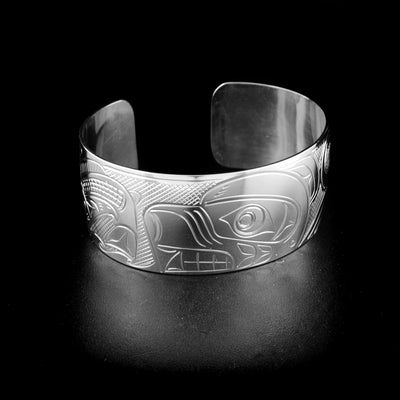 Bear and salmon cuff bracelet hand-carved by Kwakwaka'wakw artist John Lancaster. Made of sterling silver. Bracelet is 6.2" long with 0.8" gap and has width of 1".