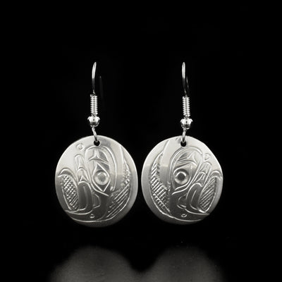 Unique oval eagle earrings hand-carved by Kwakwaka'wakw artist Don Lancaster. Made of sterling silver. Each earring measures 1.44" x 0.69" including hook.