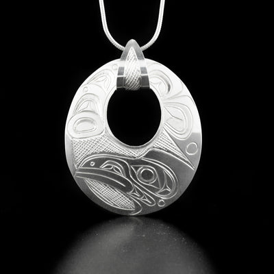 Stunning oval raven cut out pendant hand-carved by Kwakwaka'wakw artist Don Lancaster. Made of sterling silver. Pendant measures 1.88" x 1.13" including bail. Chain not included.