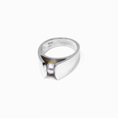 A round, white, slightly flattened pearl takes center stage on this sterling silver ring. Size 7.