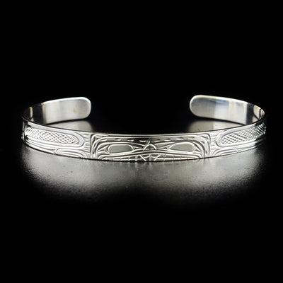 Detailed beaver bracelet hand-carved by Kwakwaka'wakw artist Victoria Harper. Made of sterling silver. Bracelet is 6.20" long with 1.10" gap and has width of 0.25".
