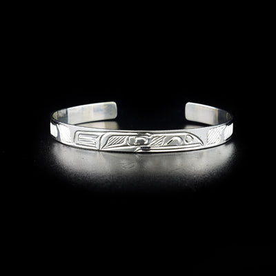 Delicate raven bracelet hand-carved by Heiltsuk artist Ivan Wilson. Made of sterling silver. Bracelet is 6.30" long with 1.20" gap and has width of 0.25".