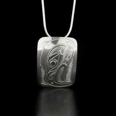 Rectangular eagle pendant hand-carved by Kwakwaka'wakw artist Don Lancaster. Made of sterling silver. Pendant measures 1.5" x 1". Hidden bail on back. Chain not included.