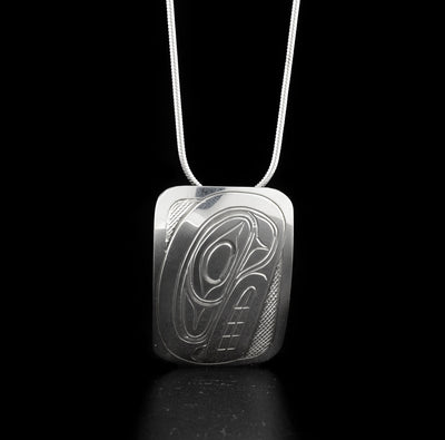 Rectangular orca pendant hand-carved by Kwakwaka'wakw artist Don Lancaster. Made of sterling silver. Pendant measures 1.25" x 1". Hidden bail on back. Chain not included.