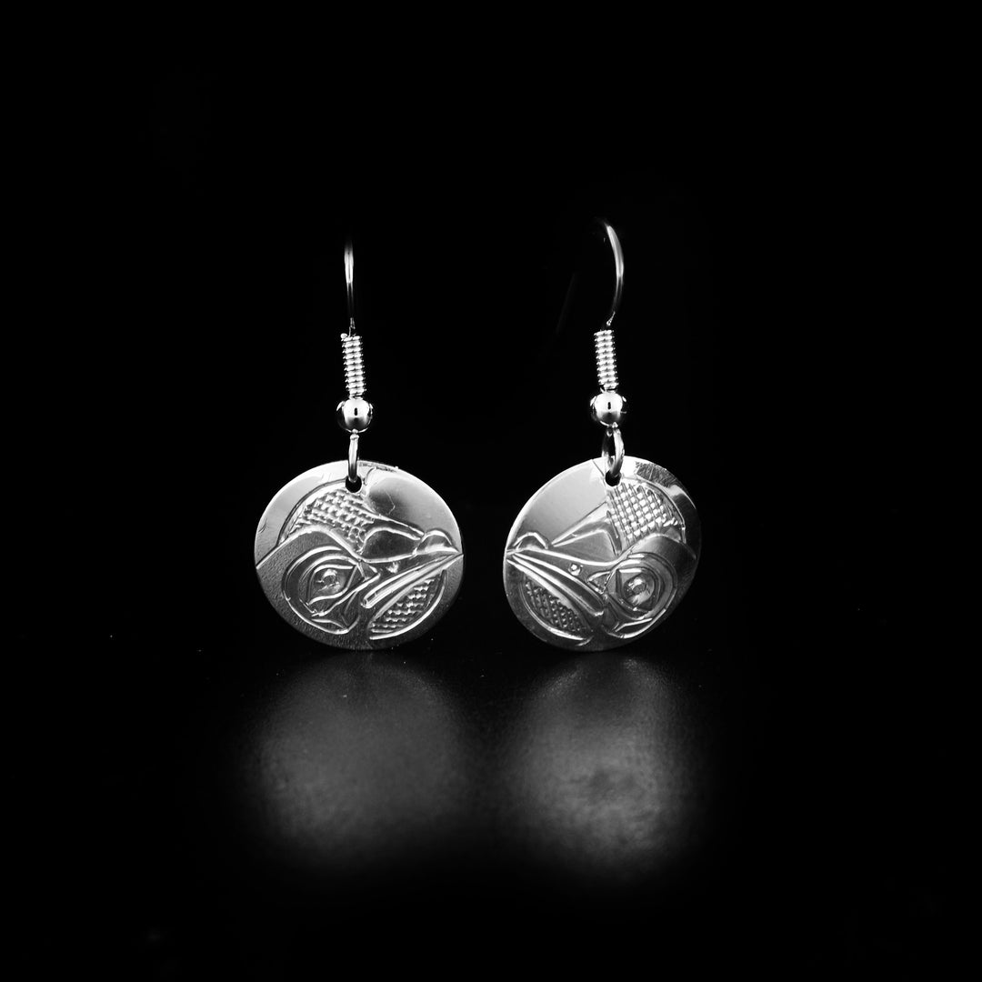 These dangling Hummingbird earrings are made form sterling silver and have circle shaped hangs. There are depictions of the Hummingbird carved into the surface of the hangs.