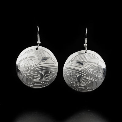 Round raven earrings hand-carved by Kwakwaka'wakw artist Don Lancaster. Made of sterling silver. Each earring measures 2" x 1.25" including hook.
