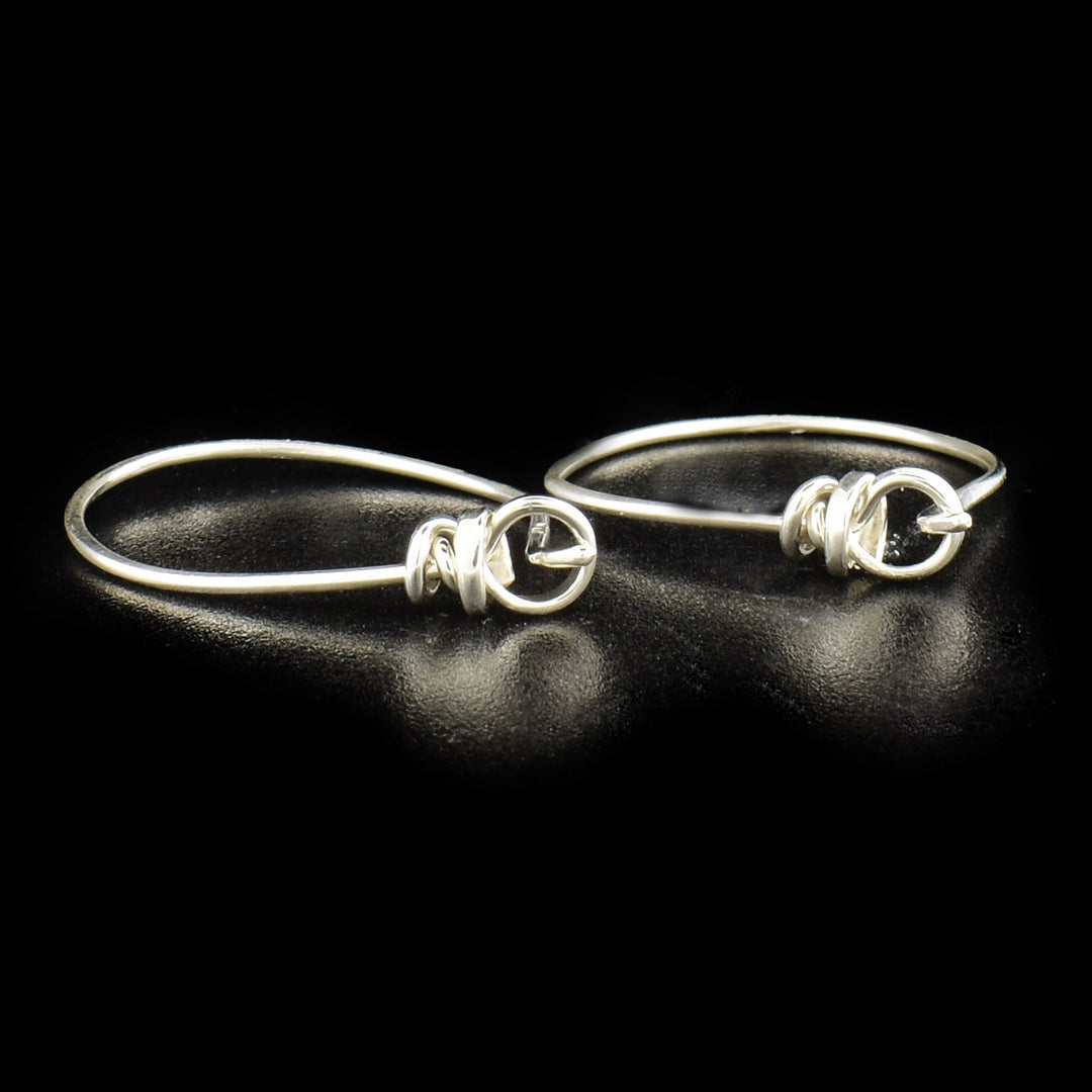 Small Tear Hoop Earrings handcrafted by artist Joy Annett. Made of sterling silver. Each earring measures 1" x 0.8".