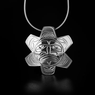 Stunning sun pendant hand-carved by Kwakwaka'wakw artist John Lancaster. Made of sterling silver. Pendant measures 1.40" x 1.40". Hidden bail on back. Chain not included. The sun symbolizes: energy, life, creative power.