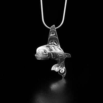 Orca pendant hand-carved by Tlingit artist Fred Myra. Made of sterling silver. Pendant measures 1.8" x 1.2". Hidden bail on back. Chain not included.